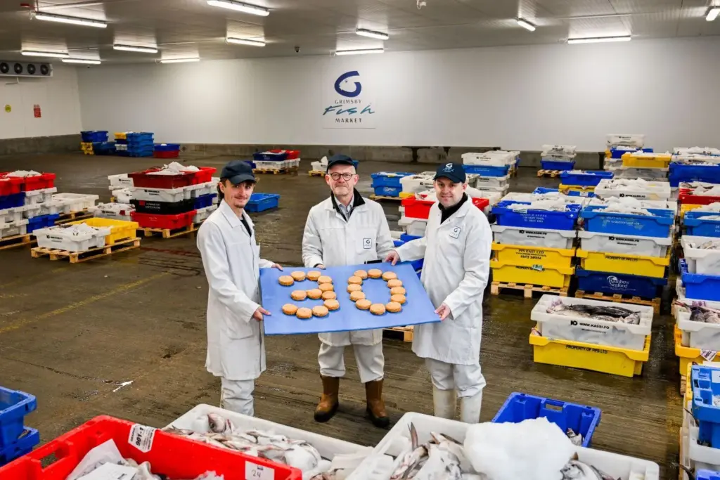 FISH CAKE CELEBRATION: Fish cakes made with haddock sourced from the auction are used to signal 30 years of Grimsby Fish Market. Pictured are, from left, Will Gibbs, trainee fish auctioneer; Nelson Hunter, fish market sales director and Danny Payne, operations director.