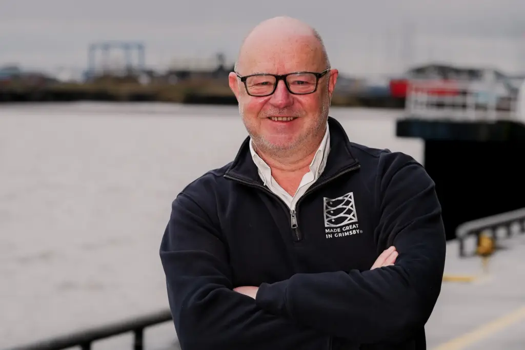 Simon Dwyer, pictured in a made Great in Grimsby branded top, on the quayside outside Grimsby Fish Market, at Port of Grimsby East.