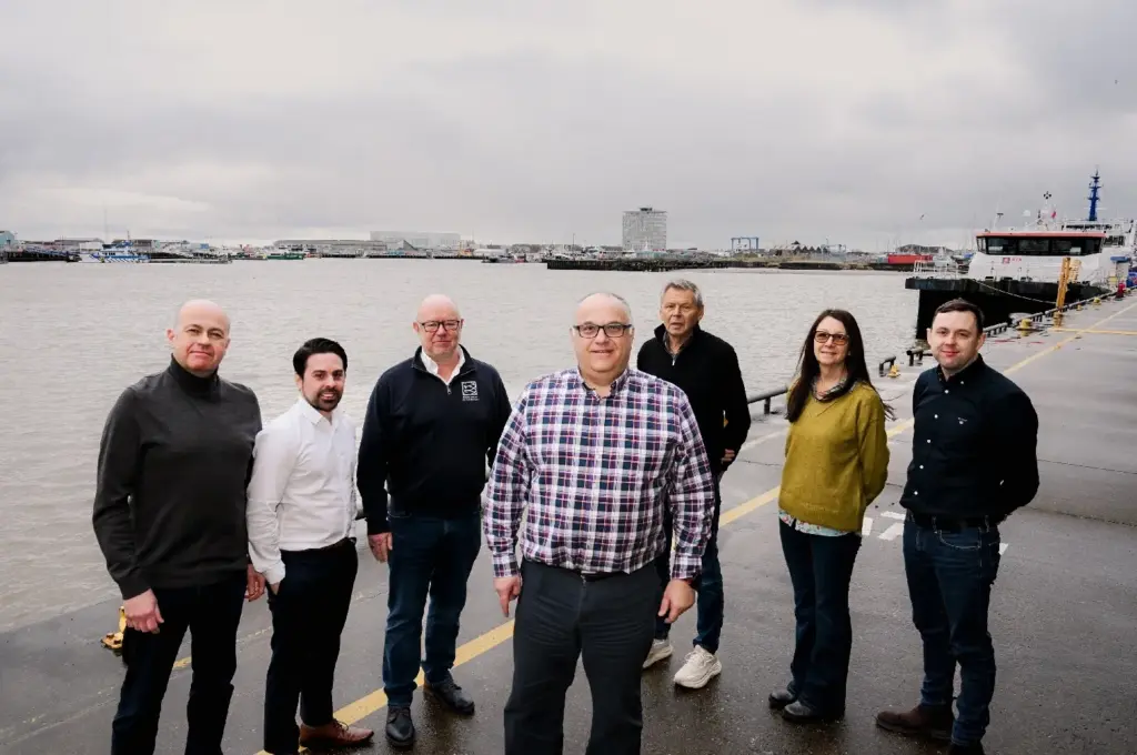 WELCOME: Andrew Oliver, chair of Grimsby Fish Dock Enterprises Ltd (centre), is to become the new chief executive of the group of companies. He is pictured on the quayside at Port of Grimsby East, with directors, from left, David Flear, Ben Walker, Simon Dwyer, Andrew Allard, Maggie Johnson and Danny Payne.