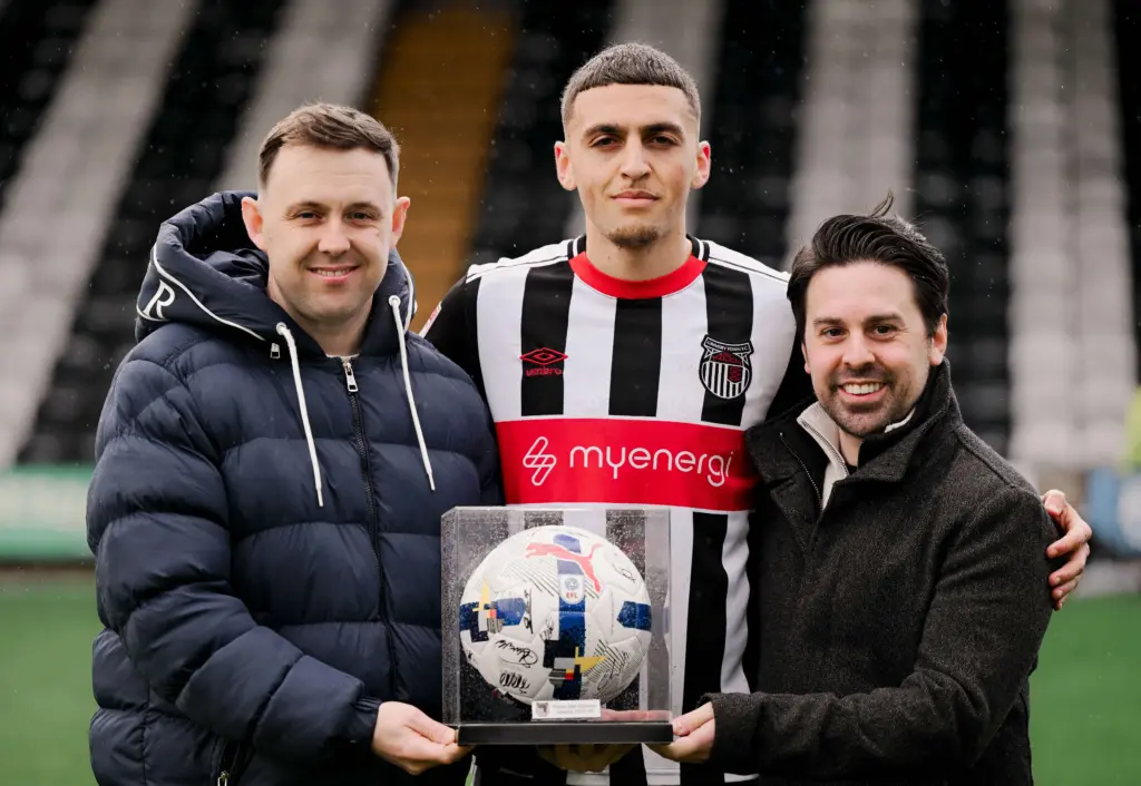 Danny Payne, left, and Ben Walker, with man of the match Jaze Kabia, at Blundell Park.