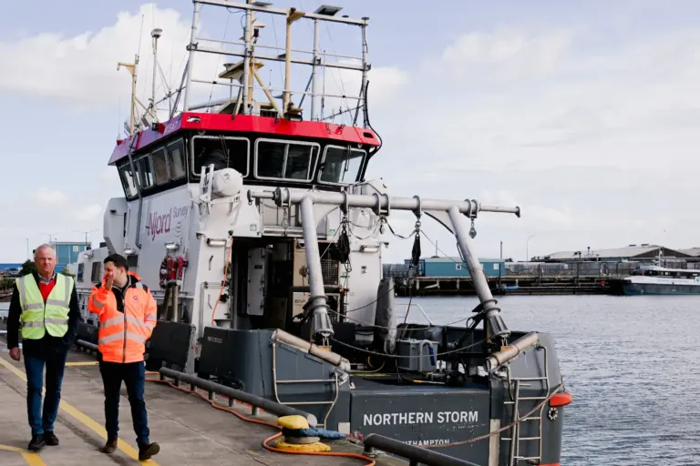 Shareholder Petur Bjornsson walks along the quayside by Grimsby Fish Market, alongside a moored vessel, with operations director Danny Payne.